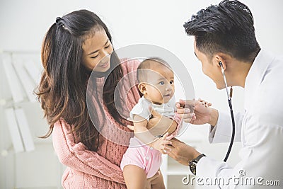 baby being checked by a doctor Stock Photo