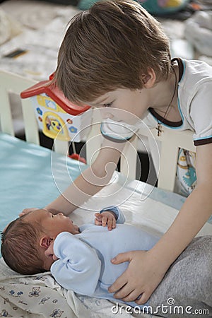 Baby being held tenderly by big brother Stock Photo