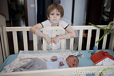 Baby being held tenderly by big brother Stock Photo