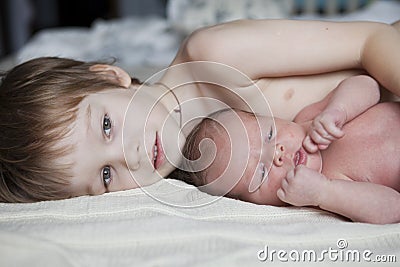 Baby being held tenderly by big brother Stock Photo