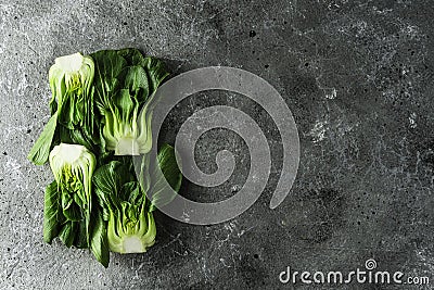 Baby bok choi halves on gray background. Top view, horizontal orientation with copy space Stock Photo