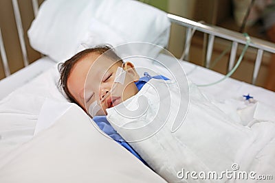 Baby boy age about 1 year old sleeping on patient bed with getting oxygen via nasal prongs to assure oxygen saturation. Intensive Stock Photo