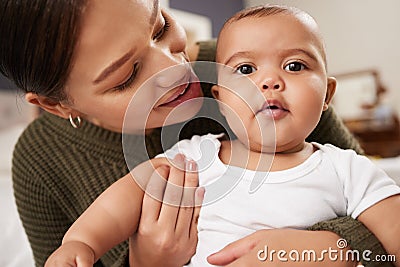 A baby boy arrives, and just like that, everything changes. a young woman carrying her baby at home. Stock Photo