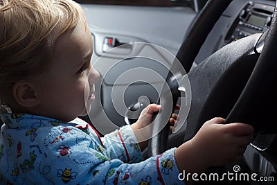 Baby boy behind the steering wheel Stock Photo