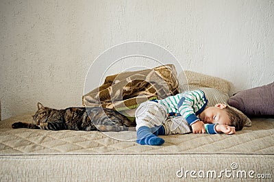 Baby boy and cat sleeping together Stock Photo