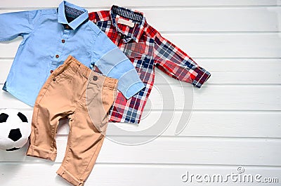 Baby boy clothing set blue shirt, plaid red shirt and brown pan Stock Photo