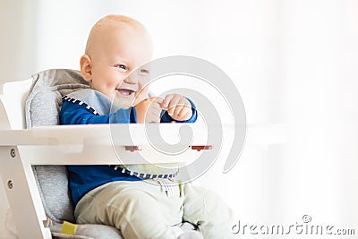 Baby boy eating with BLW method, baby led weaning Stock Photo