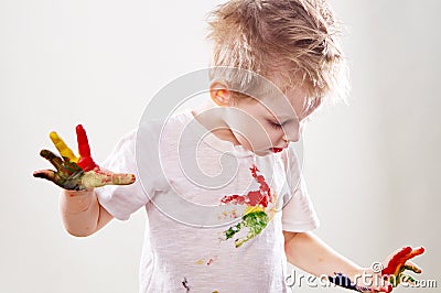 The baby boy with gouache soiled hands and shirt isolated Stock Photo