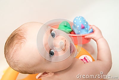 Baby boy having bath, looking Stock Photo