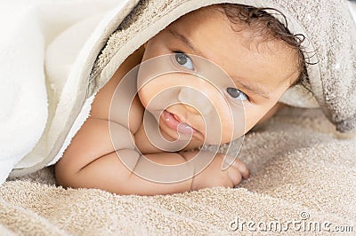 Baby boy hiding under covers Stock Photo
