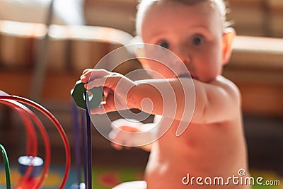 Baby boy playing with his colored toys Stock Photo