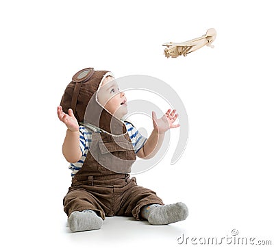 Baby boy playing with wooden plane Stock Photo