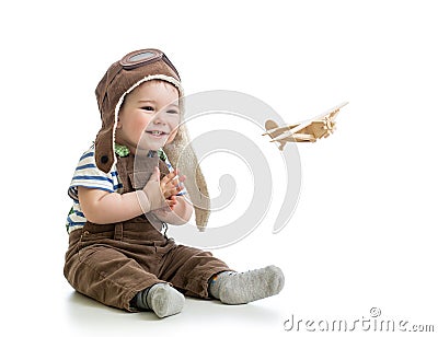 Baby boy playing with wooden plane Stock Photo