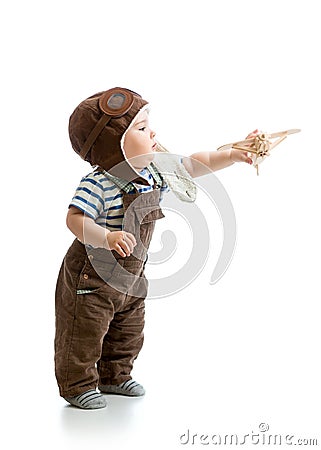 Baby boy playing with wooden plane Stock Photo