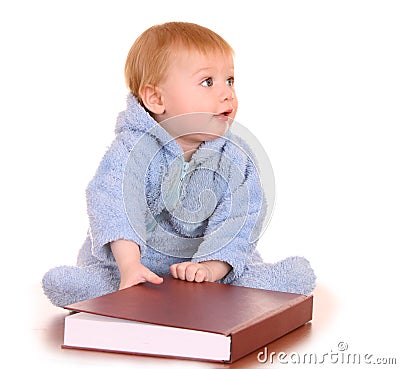 Baby boy read big red book. Stock Photo