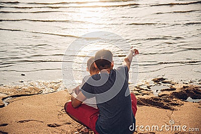 Baby boy son and father dad lifestyle happiness pointing to sea Stock Photo