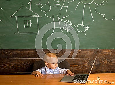 Baby boy use digital access in computer class. Developing digital literacy skills with network devices and internet Stock Photo
