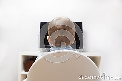 Baby boy watching cartoons on TV Stock Photo