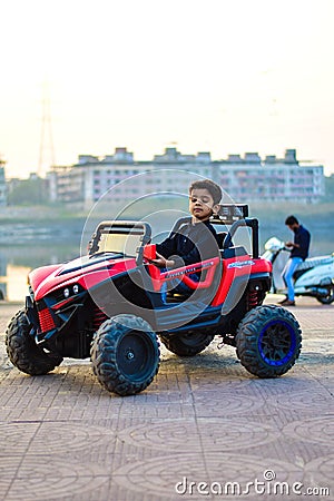 A baby boy who`s name is Raad playing in a electrical toy car Editorial Stock Photo