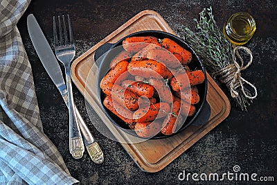 Baby carrots baked in a skillet. Stock Photo