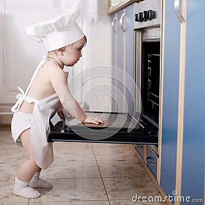 Baby chef cooks in the oven food Stock Photo