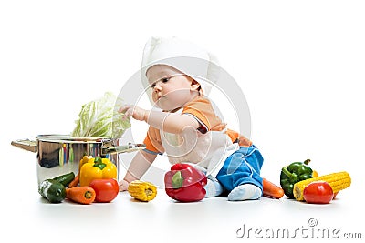 Baby chef with healthy food vegetables and pan Stock Photo