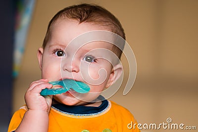 Baby chewing on teething ring Stock Photo