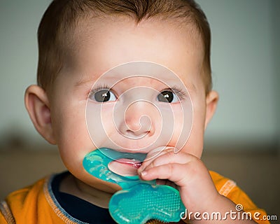 Baby chewing on teething ring Stock Photo