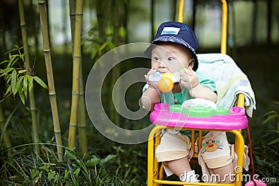 Baby chewing a toy Stock Photo