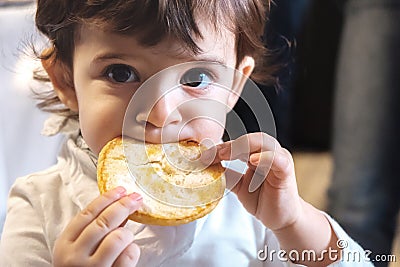 Baby child eat carbohydrates newborn eating face closeup portrait unhealthy diet for kids Stock Photo