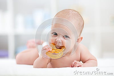 Baby child lying on belly weared diaper with teether Stock Photo