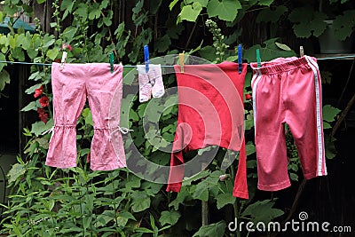 Baby clothes hanging clothes line Stock Photo