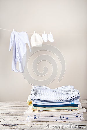Baby clothes on a rope dry. Laundry of children`s things. The concept of washing things and copy space Stock Photo