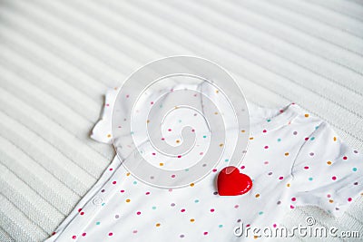 Baby clothes with symbol of heart Stock Photo