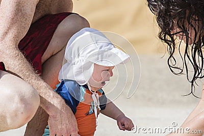 Baby Cries and Mother and Father Offer Comfort Stock Photo