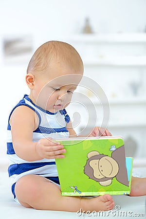 Baby curious with book Stock Photo