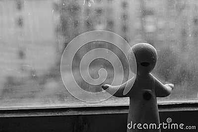 Baby-doll looking out of the window (backside) Stock Photo