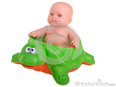 Baby Doll sitting on turtle Stock Photo
