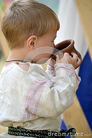 Baby is drinking from a cup Editorial Stock Photo