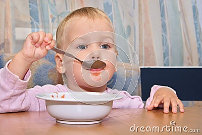 Baby eat with spoon Stock Photo