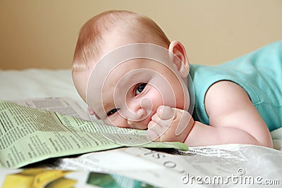 Baby eating newspaper Stock Photo