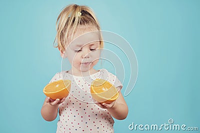 Baby eating an orange Stock Photo