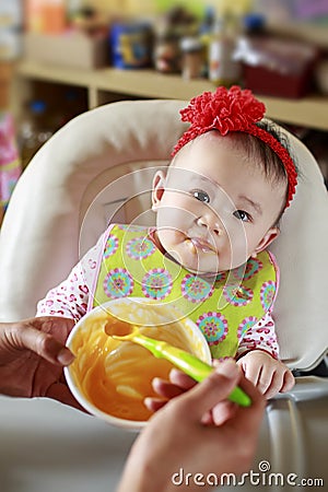 Baby Eating Solid Food Stock Photo