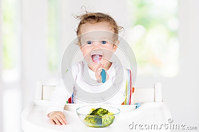 Baby eating vegetables. Solid food for infant Stock Photo