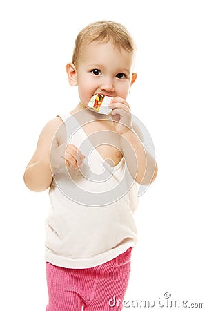 Baby eats candy on a white background Stock Photo