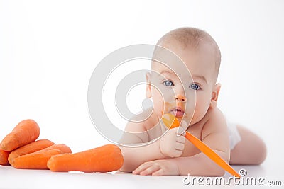 Baby eats mashed carrots Stock Photo