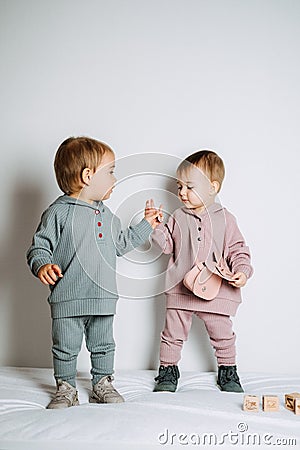 Baby fashion. Unisex clothes for babies. Two Cute baby girls or boys in cotton set Stock Photo