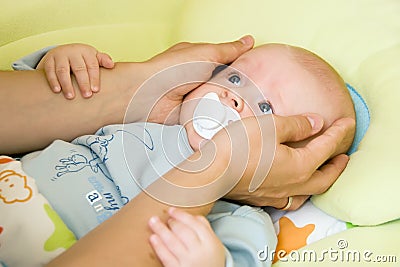 Baby with father's hands Stock Photo