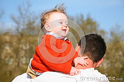 Baby on father shoulder Stock Photo