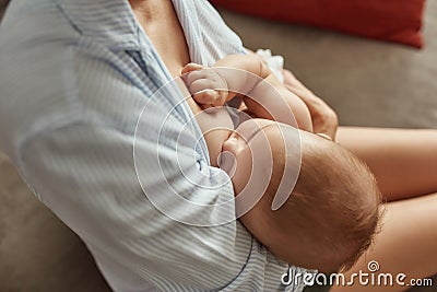 Baby feeling safe and loved while breastfeeding Stock Photo